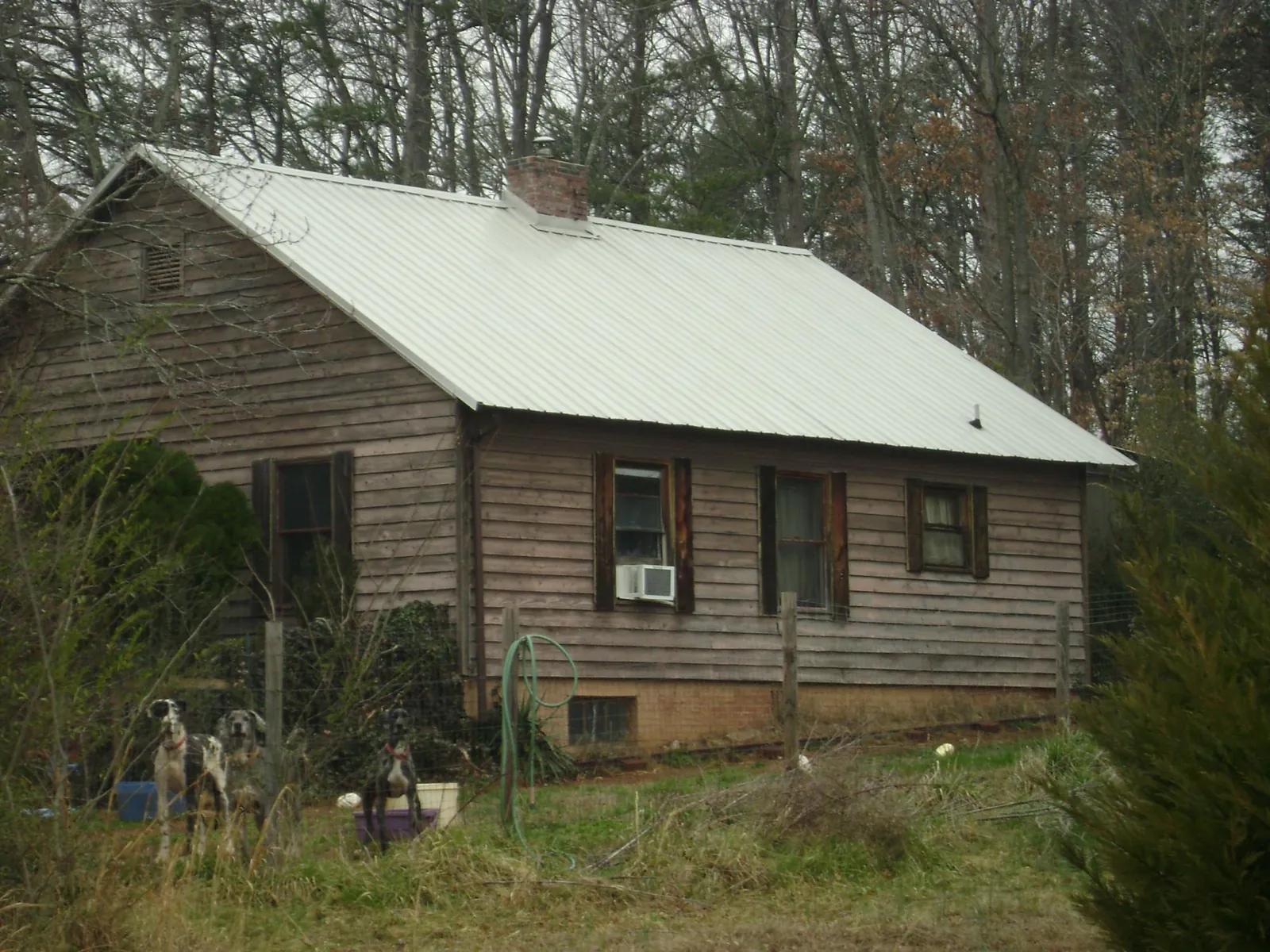 White metal roof on an old wood sided farmhouse, from a Metal Roof Installation job in Stephenson
